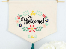 Welcome a new friend or neighbor by adding this free welcome wreath embroidery design to a dishtowel, banner, pillow or flag. #freeembroiderydesign #embroiderydesign